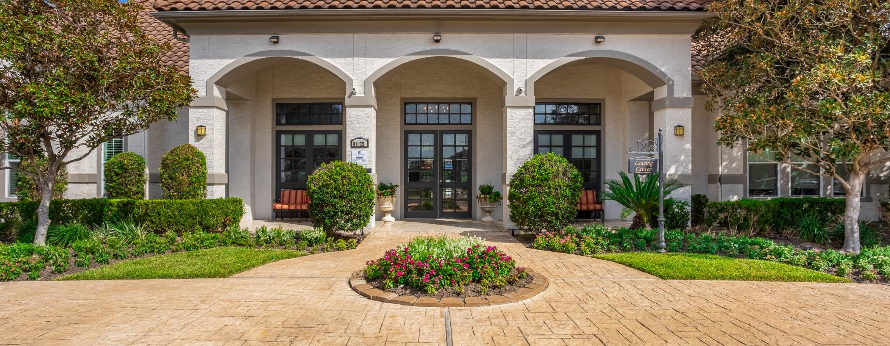 a club house with a brick driveway