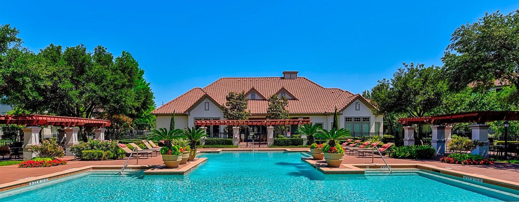 a swimming pool in front of a club house