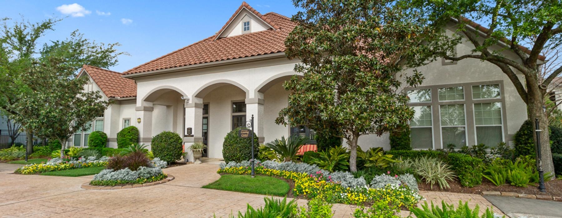 a club house with a brick driveway