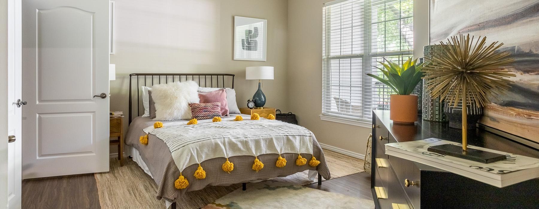 a bedroom with a bed and a fan